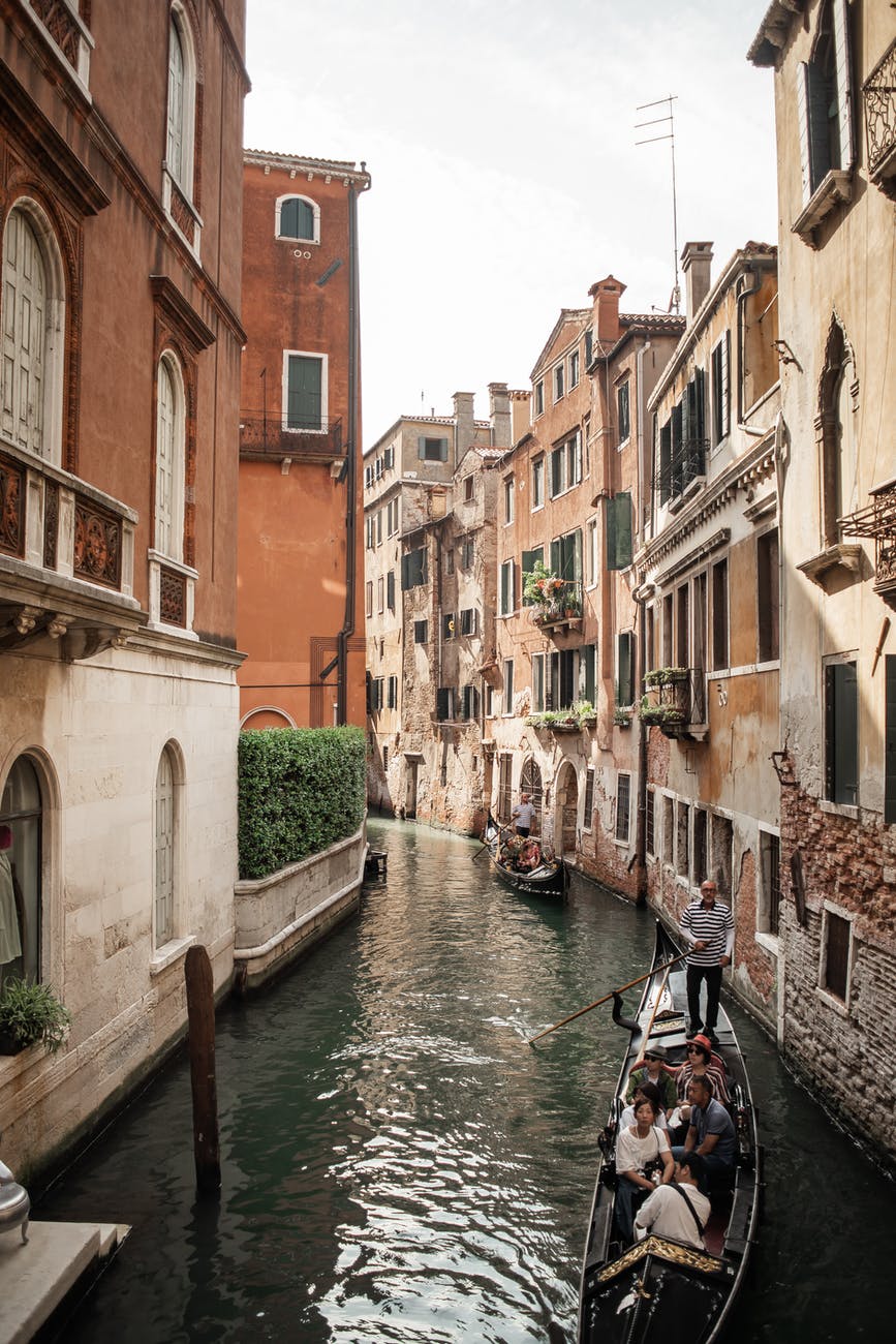 gondolas floating on narrow canal in venice